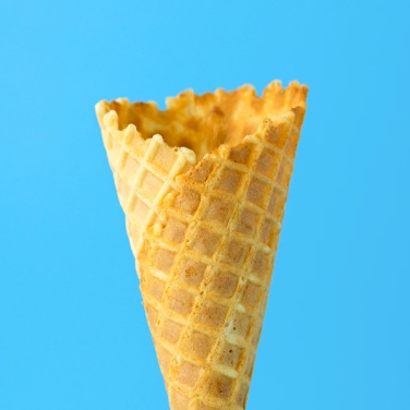 Image of a waffle cone infront of a blue background